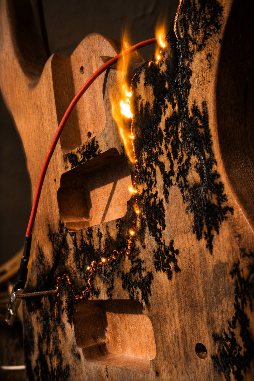 Live fractal burning across a guitar body